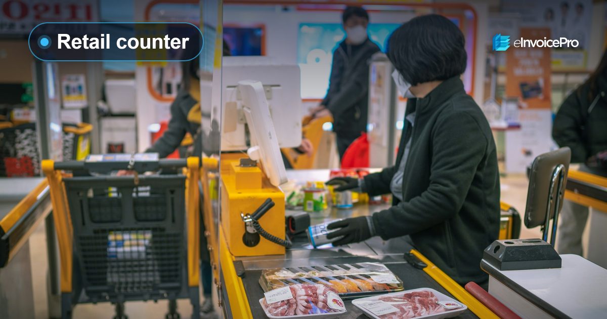 A cashier at a busy supermarket checkout