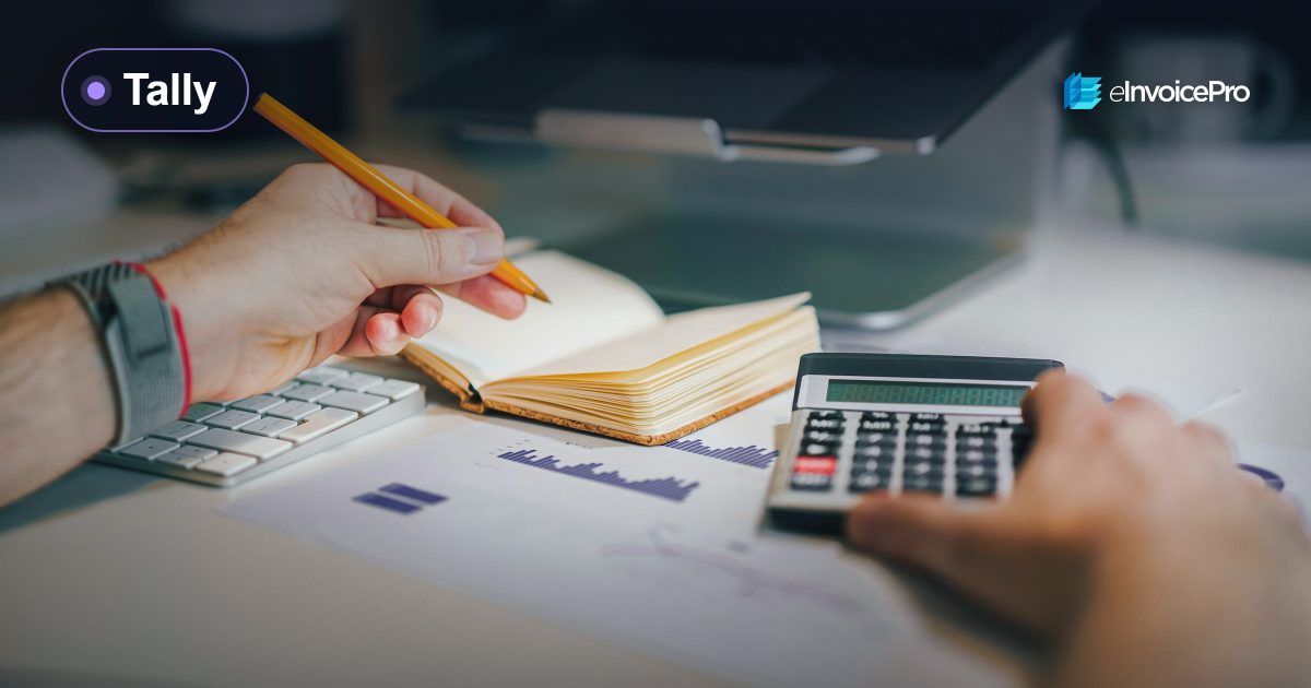 An accountant working with a calculator and a notebook